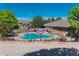 Community pool area, fenced-in for safety, decorated with patriotic bunting, and surrounded by trees at 6418 Silver Mesa Dr # C, Highlands Ranch, CO 80130