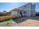Charming backyard features a wooden fence, grassy area, and a covered patio perfect for outdoor relaxation at 13931 E 104Th Dr, Commerce City, CO 80022