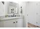 Bathroom featuring a vanity, mirror, white cabinets, and modern sink at 13931 E 104Th Dr, Commerce City, CO 80022