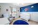 Charming room with blue accent wall, crib, and unique airplane ceiling fan at 13931 E 104Th Dr, Commerce City, CO 80022