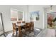 Well-lit dining room featuring gray chairs, hardwood floors, decor, and plenty of natural light at 13931 E 104Th Dr, Commerce City, CO 80022
