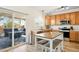 Kitchen featuring an island with seating, stainless steel appliances, and access to an outdoor deck at 13931 E 104Th Dr, Commerce City, CO 80022