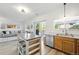 Kitchen featuring an island with seating, a view to the living room, and access to an outdoor deck at 13931 E 104Th Dr, Commerce City, CO 80022