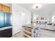Kitchen featuring an island with barstool seating that flows into the living room and stainless steel appliances at 13931 E 104Th Dr, Commerce City, CO 80022