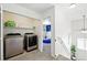 Convenient laundry area next to a bedroom with modern washer and dryer at 13931 E 104Th Dr, Commerce City, CO 80022
