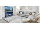 Inviting living room features a comfortable sectional sofa, fireplace, and stylish rug at 13931 E 104Th Dr, Commerce City, CO 80022