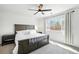 Serene main bedroom featuring a plush bed, bedside tables, and a large window, flooded with natural light at 13931 E 104Th Dr, Commerce City, CO 80022