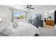 Tranquil main bedroom with a ceiling fan, large window and dresser with TV at 13931 E 104Th Dr, Commerce City, CO 80022
