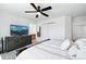Comfortable main bedroom with a ceiling fan, dresser, and closet space, perfect for relaxation at 13931 E 104Th Dr, Commerce City, CO 80022