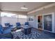 Inviting covered patio with comfortable seating, an outdoor fireplace, and a view inside at 13931 E 104Th Dr, Commerce City, CO 80022
