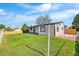 Well-maintained backyard featuring a lush lawn, white house exterior, and a clear blue sky at 6369 W 69Th Ave, Arvada, CO 80003