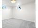 Well-lit basement room with carpet and windows, offering potential for various uses at 6369 W 69Th Ave, Arvada, CO 80003