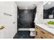 Elegant bathroom featuring marble tiled shower, modern vanity, and gold accents at 6369 W 69Th Ave, Arvada, CO 80003