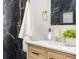 Updated bathroom with a marble tiled shower, wood vanity and gold fixtures at 6369 W 69Th Ave, Arvada, CO 80003