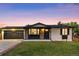 Inviting home exterior with stone accents, an attached two car garage, and pristine lawn at 6369 W 69Th Ave, Arvada, CO 80003