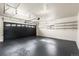 Spacious garage featuring a black garage door and painted floors at 6369 W 69Th Ave, Arvada, CO 80003
