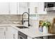 Modern kitchen featuring white cabinetry, stainless steel appliances, and sleek countertops at 6369 W 69Th Ave, Arvada, CO 80003