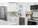 Charming kitchen featuring stainless steel appliances and beautiful backsplash at 6369 W 69Th Ave, Arvada, CO 80003