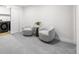 Cozy sitting area with two chairs and a small side table, next to a laundry area at 6369 W 69Th Ave, Arvada, CO 80003