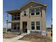 Charming two-story home featuring large windows, a covered porch, and ample natural light; ready for personalization at 24207 E 53Rd Dr, Aurora, CO 80019