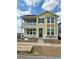 Charming two-story home featuring a covered porch, green door, many windows, and unfinished front yard at 24207 E 53Rd Dr, Aurora, CO 80019
