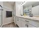 Bathroom features a double sink vanity, granite countertop, and tiled shower at 18096 E 104Th Way, Commerce City, CO 80022