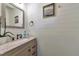 Charming bathroom featuring shiplap walls, granite countertop and modern fixtures at 18096 E 104Th Way, Commerce City, CO 80022