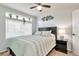 Comfortable bedroom with a serene color scheme, natural light, and a ceiling fan at 18096 E 104Th Way, Commerce City, CO 80022