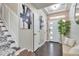 Welcoming entryway features stylish decor, hardwood floors, and ample natural light at 18096 E 104Th Way, Commerce City, CO 80022