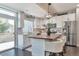 Modern kitchen boasts stainless steel appliances, white cabinets, and a spacious island with seating at 18096 E 104Th Way, Commerce City, CO 80022