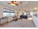 Spacious living room with multiple ceiling fans, a large window, and plenty of natural light at 18096 E 104Th Way, Commerce City, CO 80022