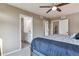 Serene main bedroom with neutral tones, ceiling fan, and en-suite bathroom access at 18096 E 104Th Way, Commerce City, CO 80022