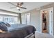 Bright main bedroom featuring a walk-in closet and ample natural light from large windows at 18096 E 104Th Way, Commerce City, CO 80022