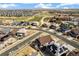 Expansive aerial view showing the property within a vibrant neighborhood, golf course, and open spaces at 7743 S Quantock Way, Aurora, CO 80016