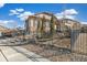 Fenced backyard with manicured landscaping, rock features and a view of the custom backyard patio at 7743 S Quantock Way, Aurora, CO 80016