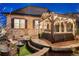 Inviting backyard featuring a cozy lounge area with fire pit and string lights at 7743 S Quantock Way, Aurora, CO 80016