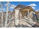 Backyard view showcasing the covered patio with stone pillars, a pergola, and outdoor seating area at 7743 S Quantock Way, Aurora, CO 80016