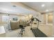 Open basement featuring a seating area, wet bar, and exercise equipment, offering versatile space at 7743 S Quantock Way, Aurora, CO 80016