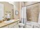 Tiled bathroom with tub and shower combination, vanity, framed art, and a traditional style at 7743 S Quantock Way, Aurora, CO 80016