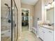 Bathroom featuring a walk in shower, single vanity, and walk in closet at 7743 S Quantock Way, Aurora, CO 80016