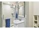 This bathroom is outfitted with a walk-in shower with glass door and single sink vanity at 7743 S Quantock Way, Aurora, CO 80016