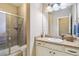 Neutral bathroom featuring a walk-in shower with a glass door and a sink with a single lever faucet at 7743 S Quantock Way, Aurora, CO 80016
