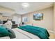 Bedroom featuring a large bed, TV, workstation, and a comfortable seating area at 7743 S Quantock Way, Aurora, CO 80016
