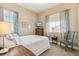 Cozy bedroom with natural light, featuring neutral walls, carpet, and stylish curtains over a double hung window at 7743 S Quantock Way, Aurora, CO 80016