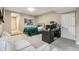 This room with a large sofa and bed setup offers relaxation and rest, complete with a TV and desk at 7743 S Quantock Way, Aurora, CO 80016