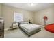 This cozy bedroom features neutral walls, a comfortable bed, and a bright window, creating a peaceful retreat at 7743 S Quantock Way, Aurora, CO 80016