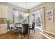 Charming dining area featuring a modern chandelier and sliding glass doors to the patio at 7743 S Quantock Way, Aurora, CO 80016