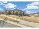 Well-maintained home with a tidy front lawn, stone accents, and convenient sidewalk access at 7743 S Quantock Way, Aurora, CO 80016