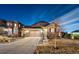 Charming two-story home with a well-manicured lawn and a two-car garage, showcasing its appealing curb appeal at twilight at 7743 S Quantock Way, Aurora, CO 80016