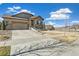 Inviting exterior of a modern home with a well-kept lawn, driveway, and a two car garage at 7743 S Quantock Way, Aurora, CO 80016